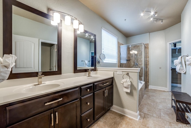 bathroom featuring tile patterned floors, vanity, and separate shower and tub