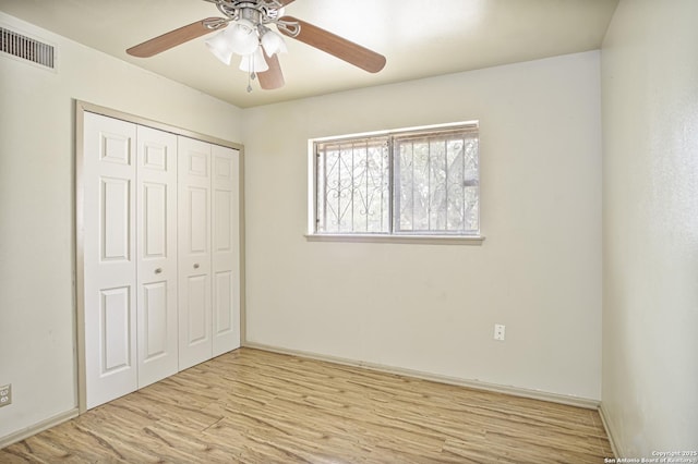 unfurnished bedroom featuring ceiling fan, a closet, and light hardwood / wood-style flooring