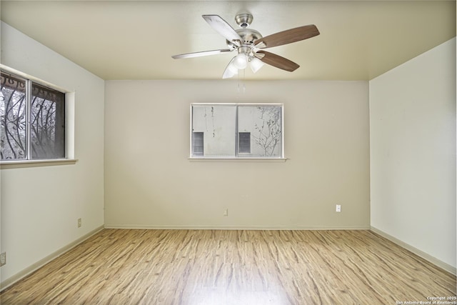 empty room with ceiling fan and light hardwood / wood-style floors