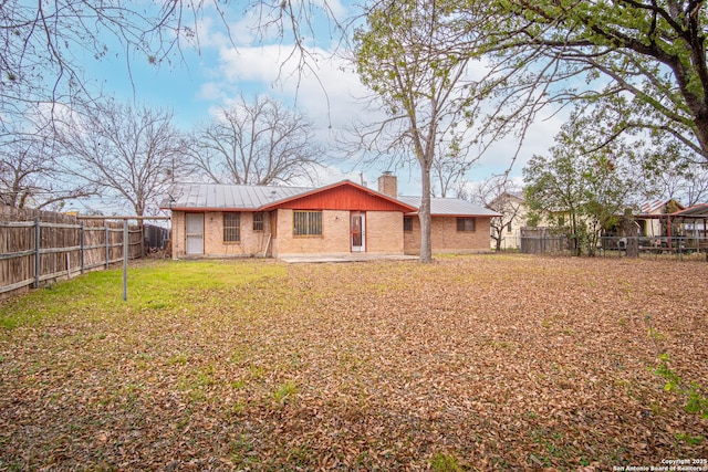 rear view of house featuring a lawn