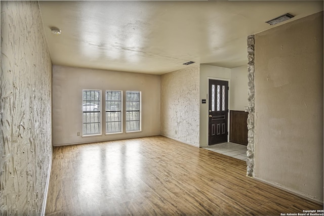 empty room with light hardwood / wood-style flooring