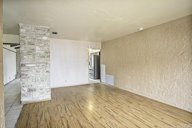 empty room with wood-type flooring