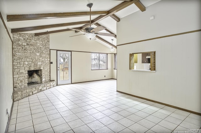 unfurnished living room featuring ceiling fan, light tile patterned floors, a stone fireplace, and vaulted ceiling with beams