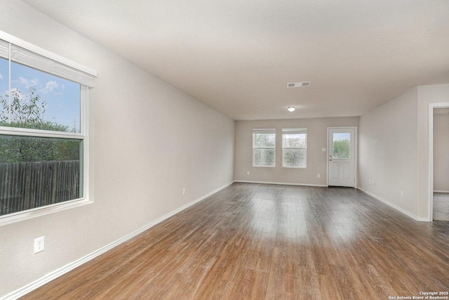 unfurnished living room featuring hardwood / wood-style flooring