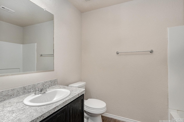 bathroom with toilet and vanity