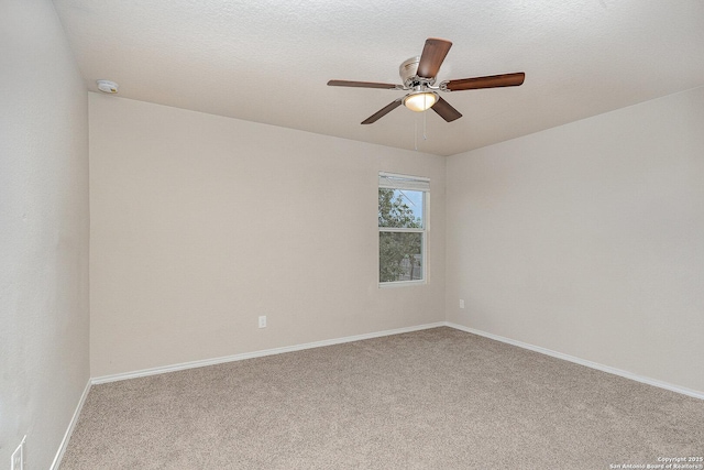 unfurnished room with ceiling fan and carpet flooring