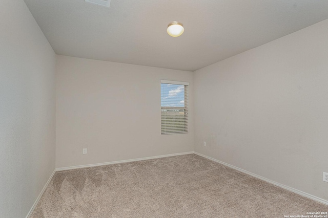 unfurnished room featuring light carpet