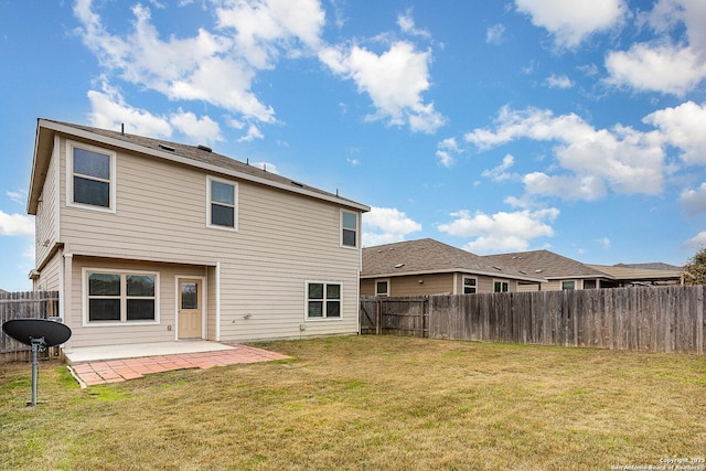 back of house with a lawn and a patio