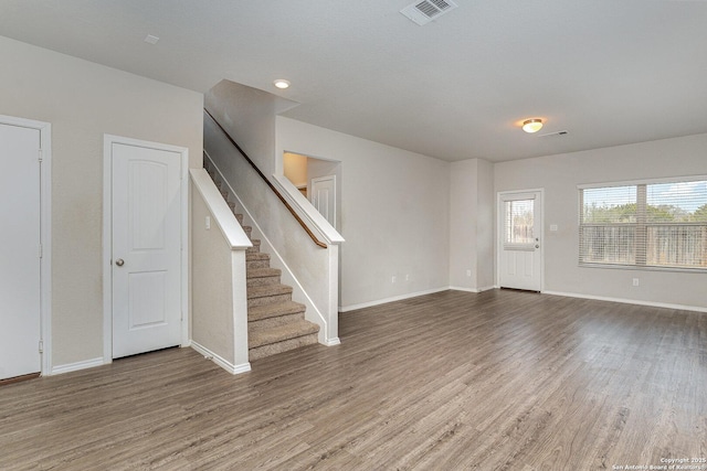 unfurnished living room featuring hardwood / wood-style floors