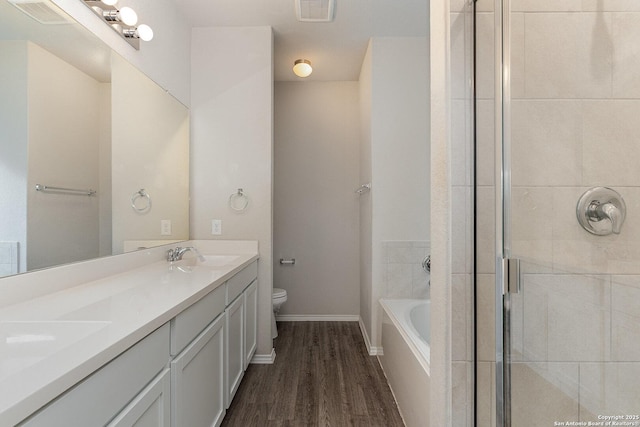 full bathroom with toilet, vanity, independent shower and bath, and hardwood / wood-style floors