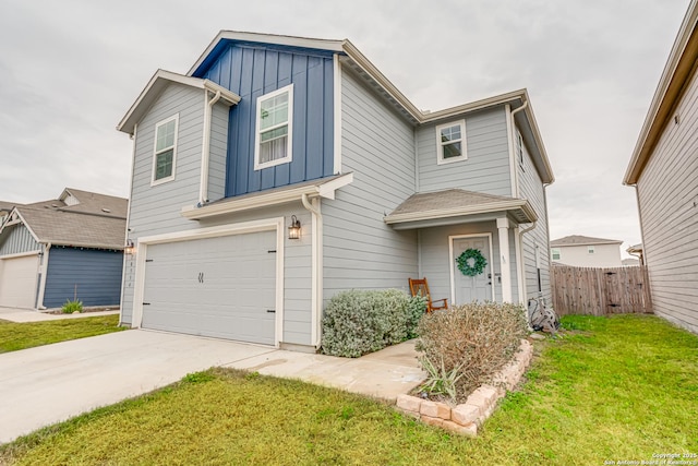 view of front of home featuring a front lawn and a garage