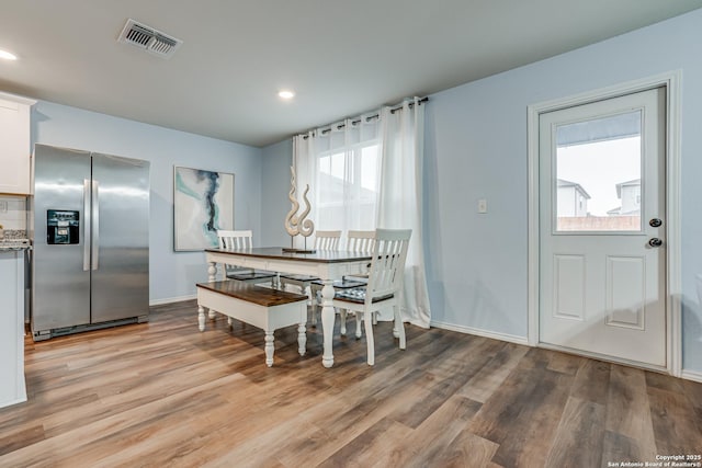 dining space with light wood-type flooring