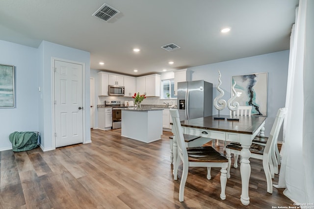 dining space with light hardwood / wood-style floors