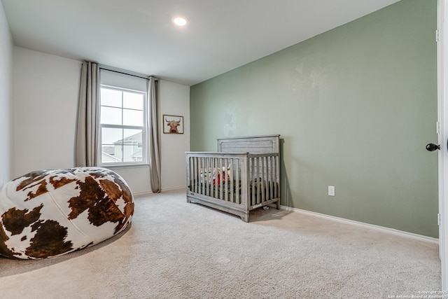 bedroom with carpet and a nursery area