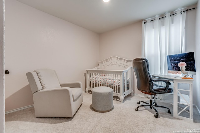 bedroom with carpet and a crib