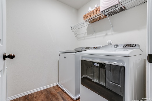 washroom featuring dark hardwood / wood-style flooring and independent washer and dryer