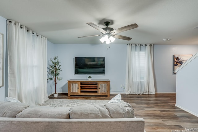 living room featuring ceiling fan and hardwood / wood-style flooring