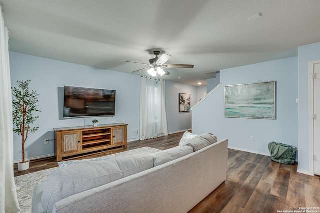 living room with ceiling fan and dark hardwood / wood-style floors