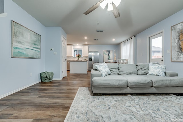 living room with ceiling fan and hardwood / wood-style flooring