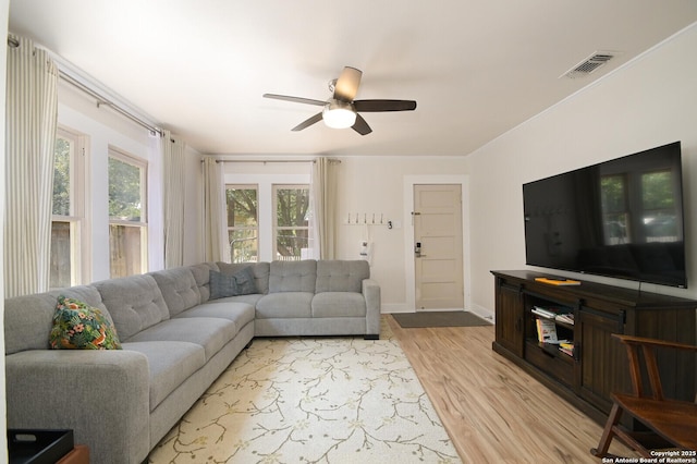 living room featuring ceiling fan and light hardwood / wood-style flooring