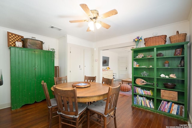 dining area with ceiling fan and dark hardwood / wood-style floors