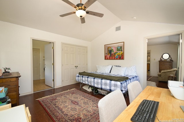 bedroom with vaulted ceiling, ceiling fan, dark hardwood / wood-style flooring, and a closet