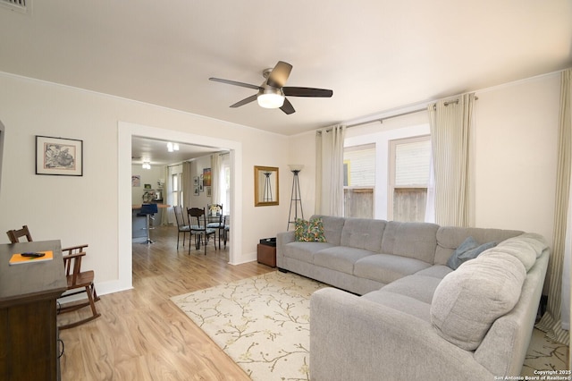 living room with ceiling fan and light hardwood / wood-style flooring