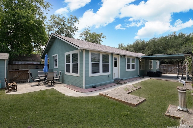 back of property featuring a lawn and a patio