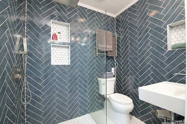 bathroom featuring toilet, tile patterned floors, walk in shower, crown molding, and sink