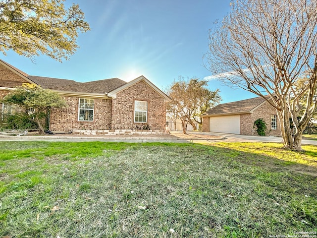 ranch-style home featuring a garage and a front yard