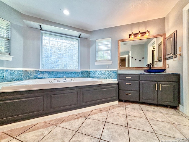 bathroom featuring tile patterned floors, a washtub, and vanity