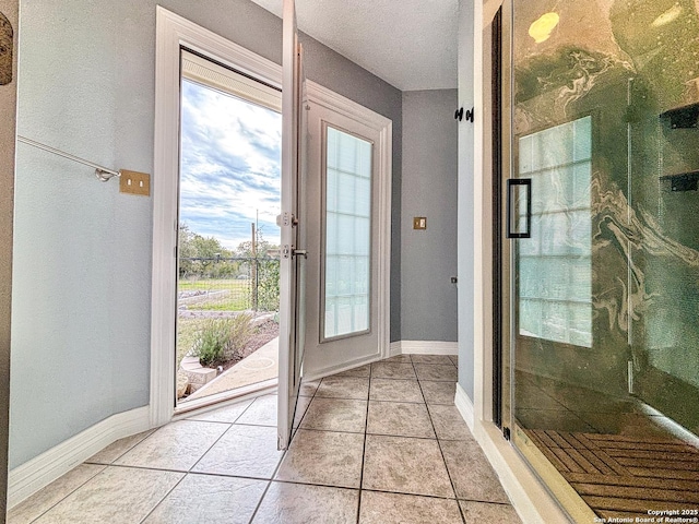 doorway to outside featuring light tile patterned floors