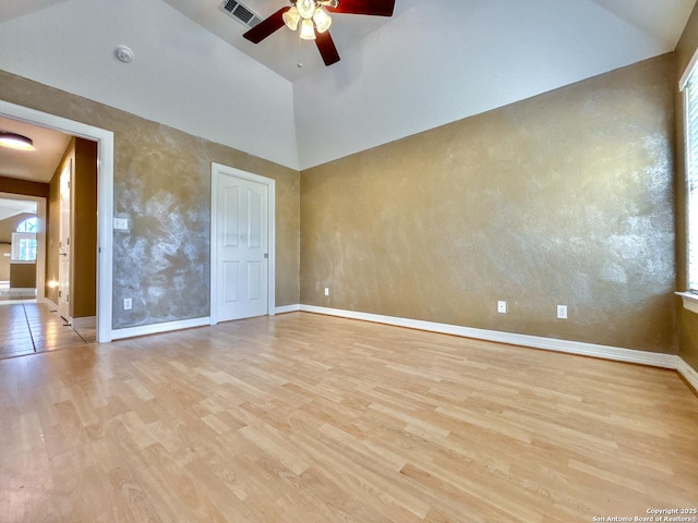 interior space with ceiling fan, light wood-type flooring, and high vaulted ceiling