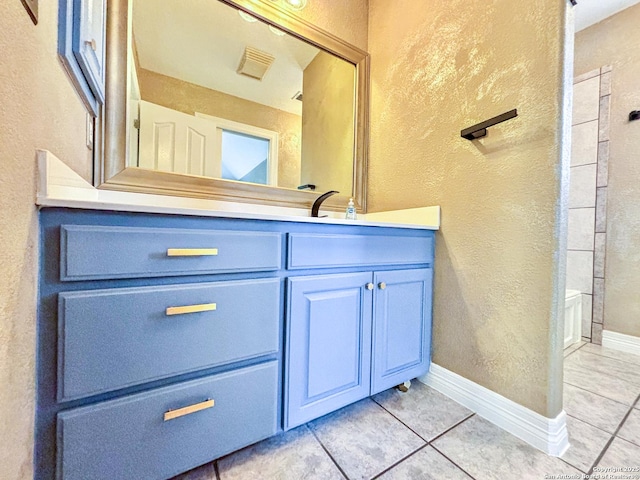 bathroom with tile patterned floors and vanity