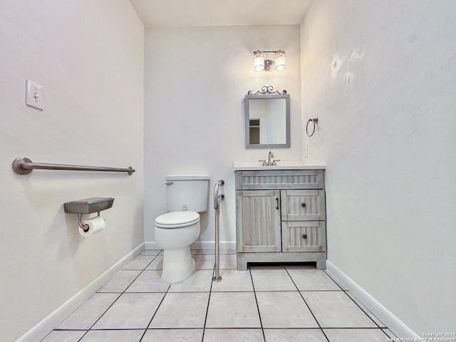 bathroom with tile patterned floors, vanity, and toilet