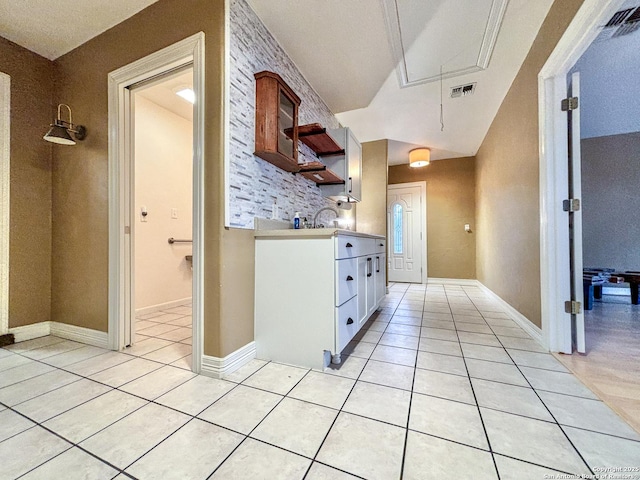 kitchen with white cabinets and light tile patterned floors