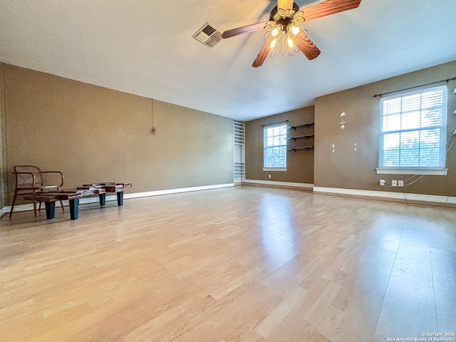 empty room featuring light wood-type flooring and ceiling fan