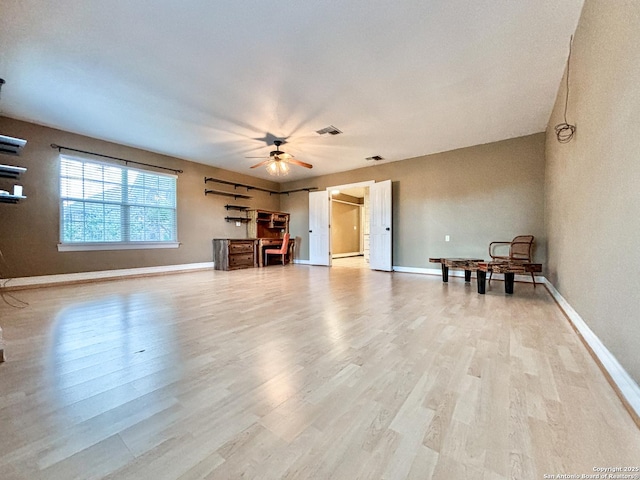 unfurnished living room with ceiling fan and light hardwood / wood-style flooring