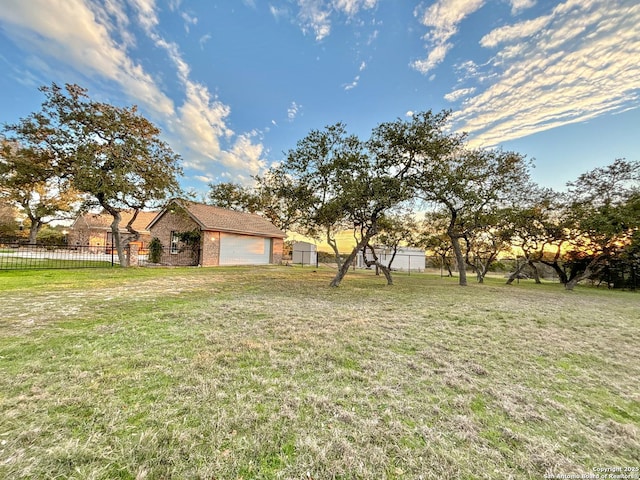 view of yard with a garage and an outbuilding