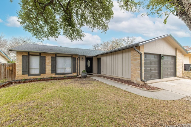 single story home with a garage and a front yard