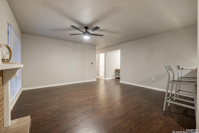 living room featuring dark wood-type flooring and ceiling fan