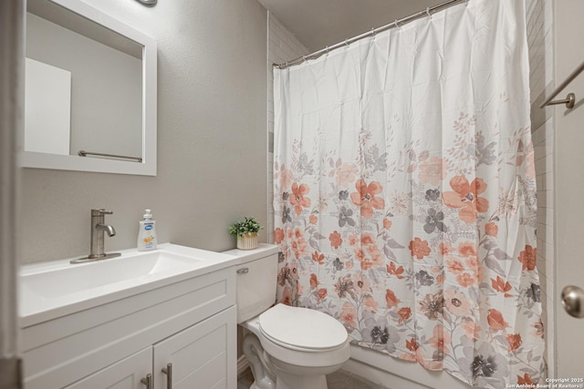 bathroom featuring toilet, walk in shower, and vanity