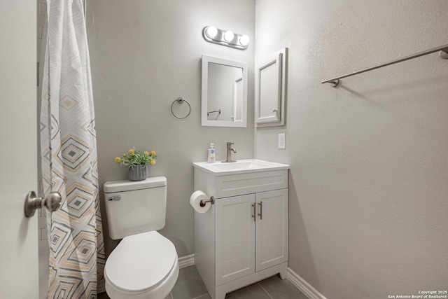 bathroom featuring toilet, tile patterned floors, and vanity