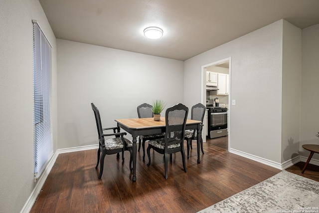 dining space with dark hardwood / wood-style floors