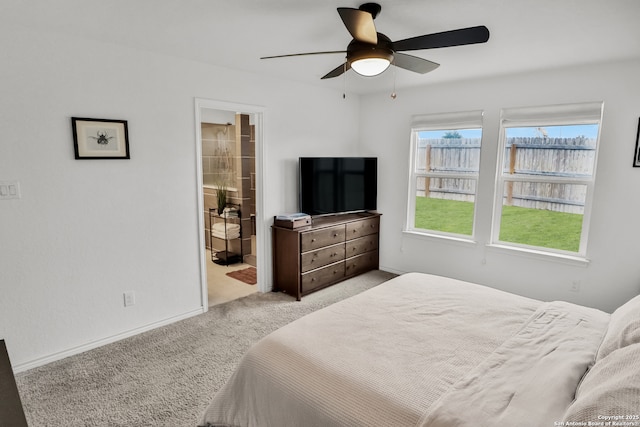 carpeted bedroom featuring ceiling fan and ensuite bathroom