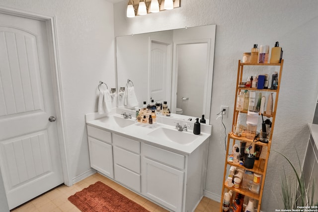 bathroom featuring toilet and vanity