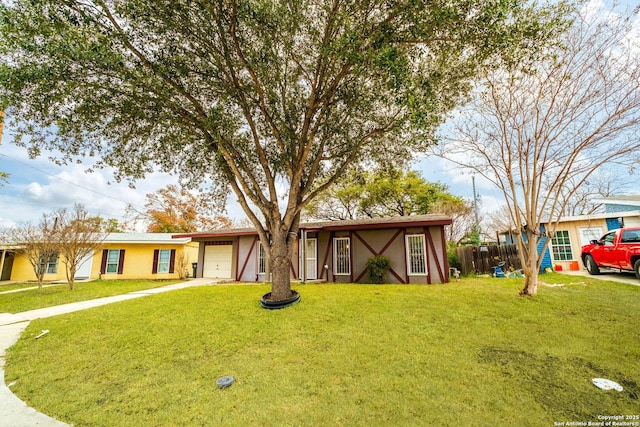 ranch-style home featuring a garage and a front yard