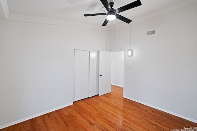 empty room with ceiling fan and hardwood / wood-style floors