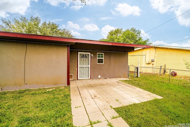 rear view of property with a patio area and a yard