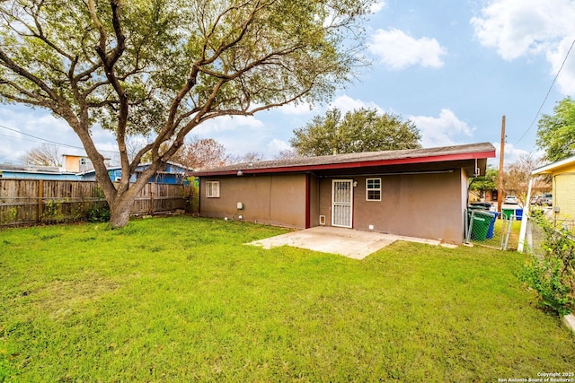 rear view of house featuring a patio and a yard